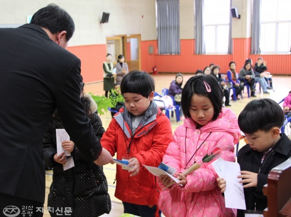 이규호 도안초 동문회장이 입학생들에게 통장과 선물을 전달하고 있다. 