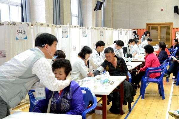 굿닥터스 나눔단 한의사가 19일 도안초등학교 체육관에서 주민을 진단하고 있다.